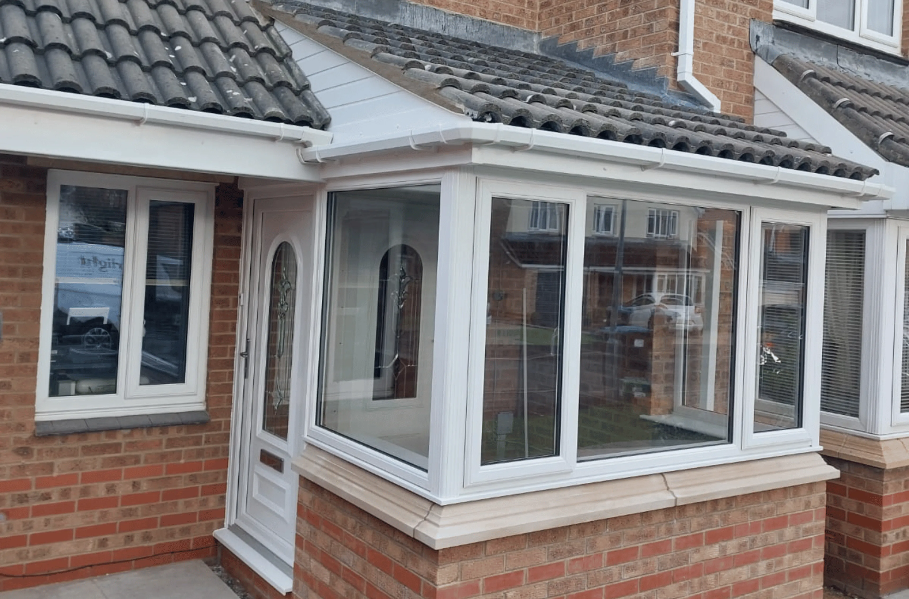 Front White uPVC porch with tiled roof 